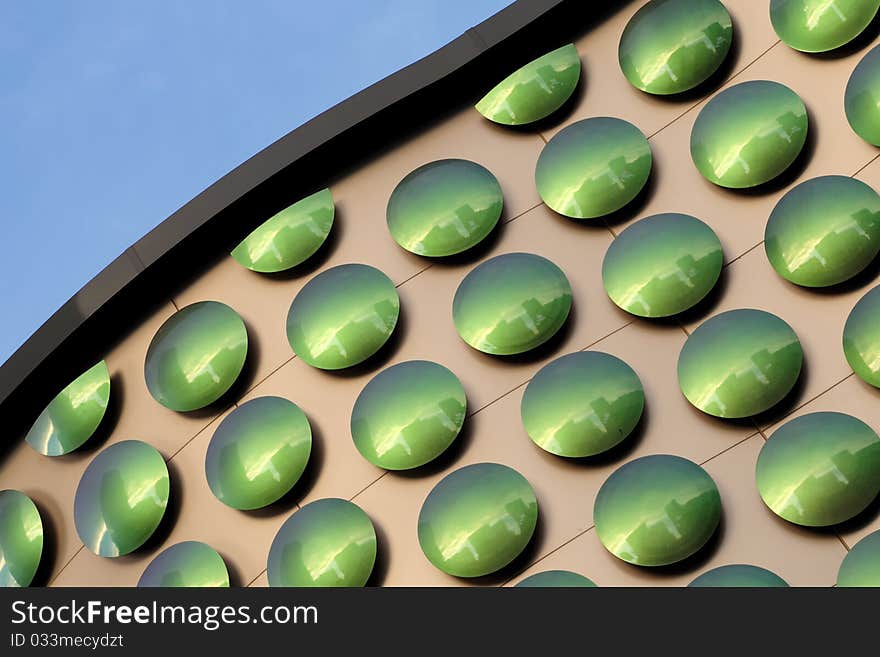 Green dots on the exterior wall of a building for a pattern