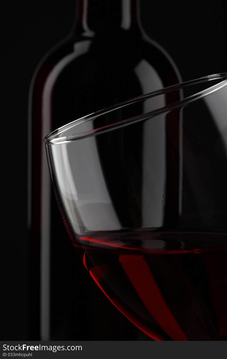 Half of red wine glass isolated on black background