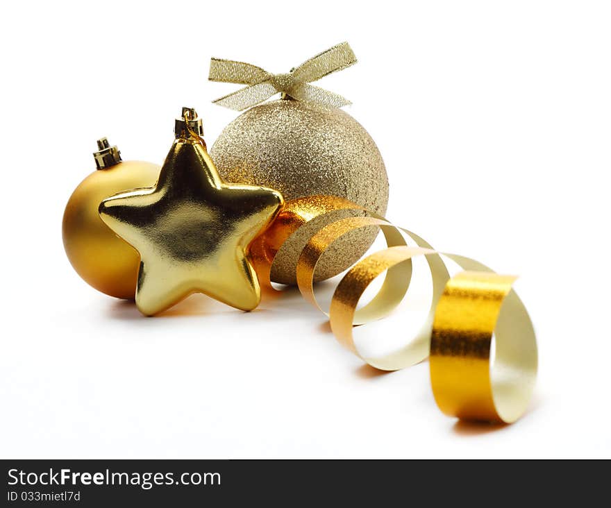 Christmas golden balls hanging with ribbons on white background