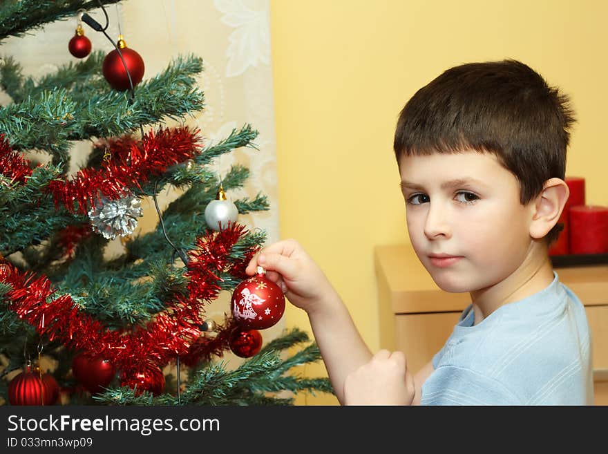 Young boy holding Christmas decorations