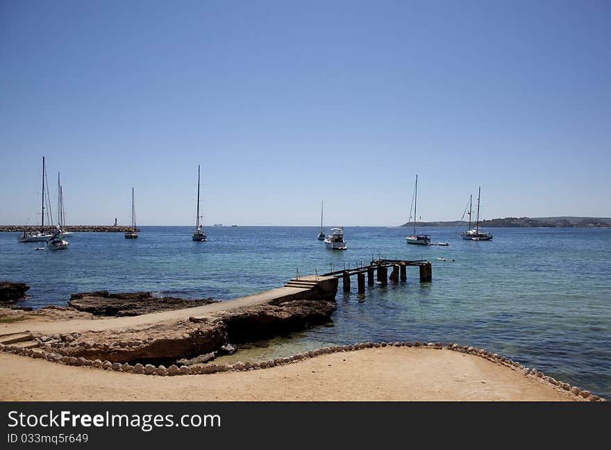 Seascape with pier and sails