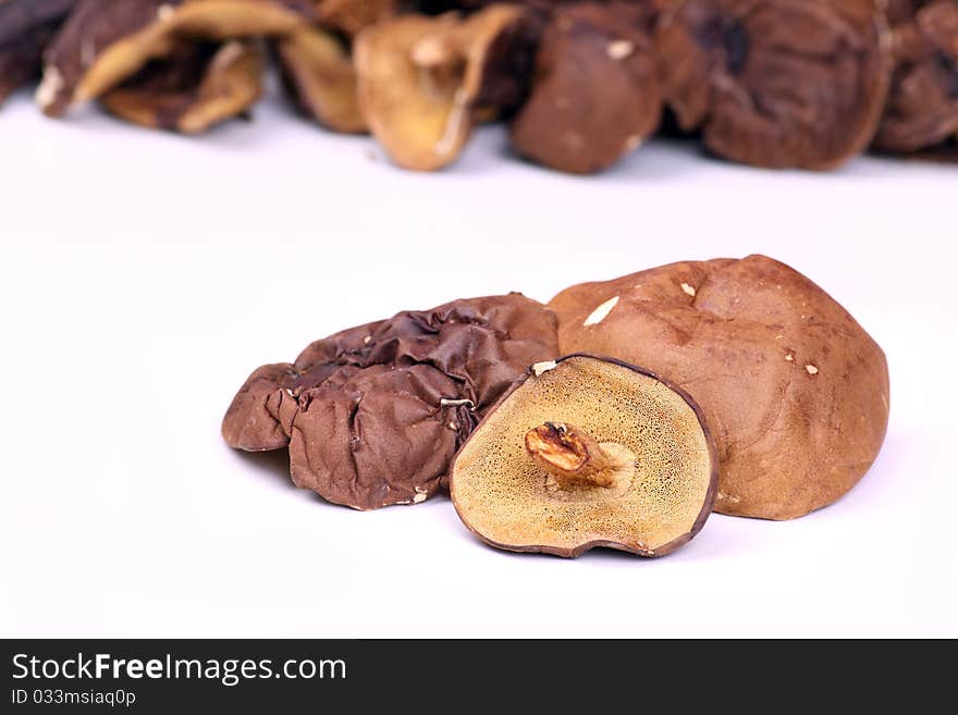 A few dried mushrooms on a white background. A few dried mushrooms on a white background