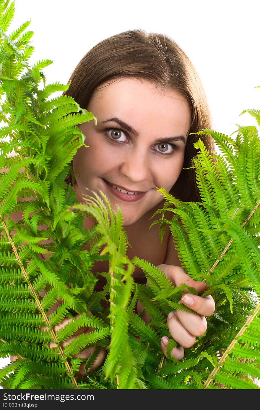 Portrait of a young beautiful woman with fern. White background. Studio shot.