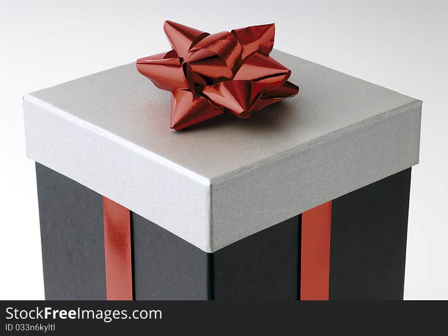 Gift in a box with red ribbon