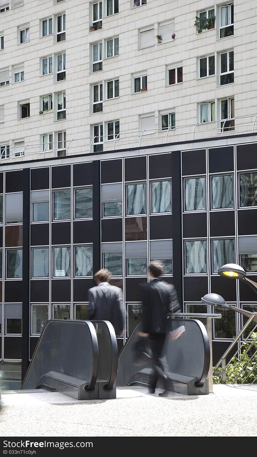 Two Businessmen Walking in Financial District, Motion Blur