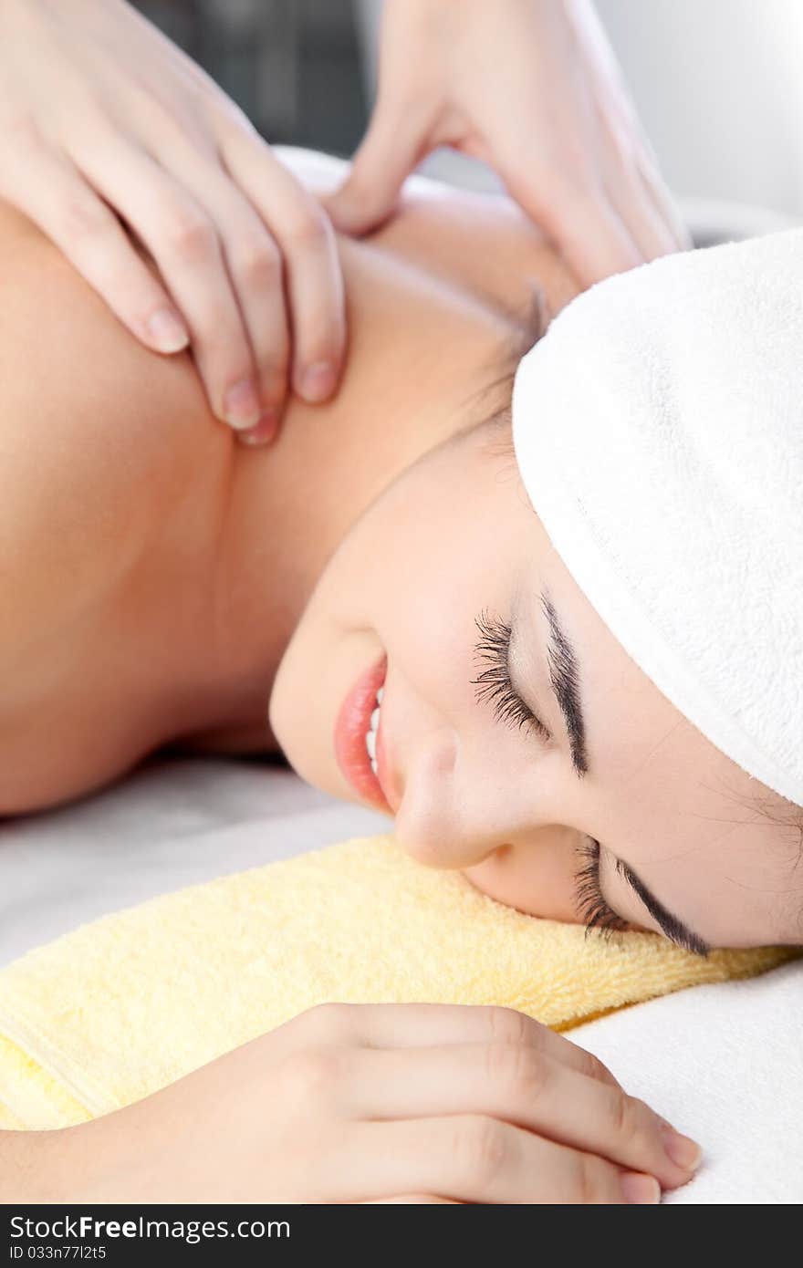 Woman in spa on white towel with blond hair