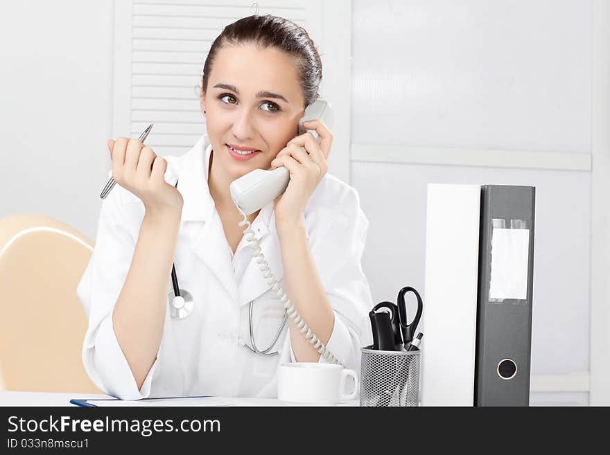 Female medical doctor working with a microscope. Female medical doctor working with a microscope