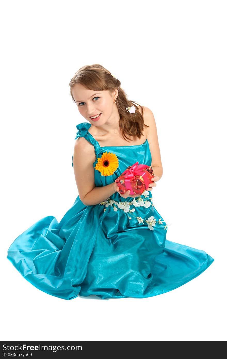 Young beautiful woman with a Christmas gift and flowers. Young beautiful woman with a Christmas gift and flowers.