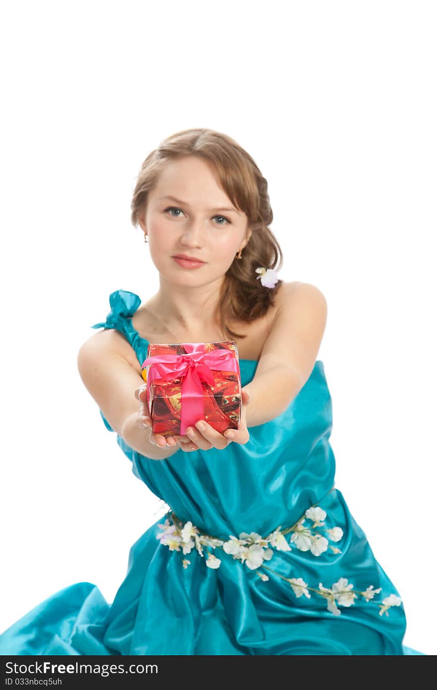 Young beautiful woman with a Christmas gift and flowers. Young beautiful woman with a Christmas gift and flowers.