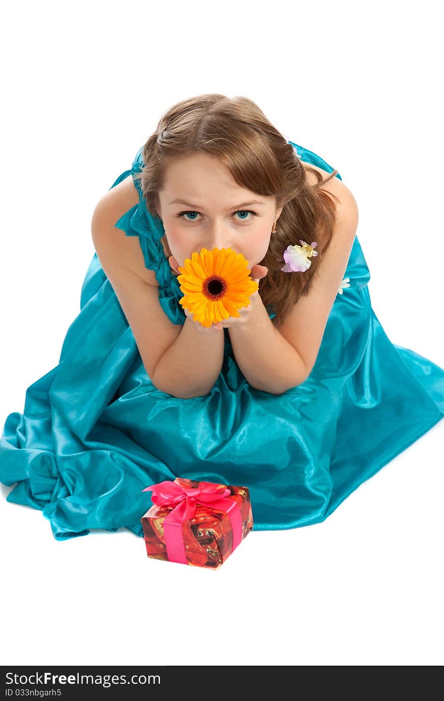 Young beautiful woman with a Christmas gift and flowers. Young beautiful woman with a Christmas gift and flowers.