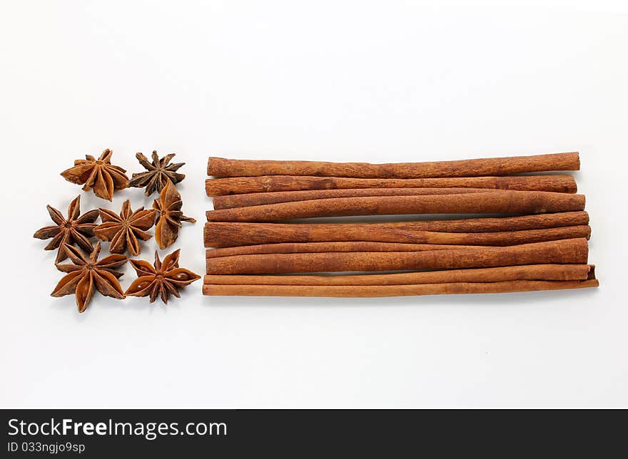 Star anise (Illicium verum) and cinnamon (Cinnamomum verum) sticks on white background. Star anise (Illicium verum) and cinnamon (Cinnamomum verum) sticks on white background.