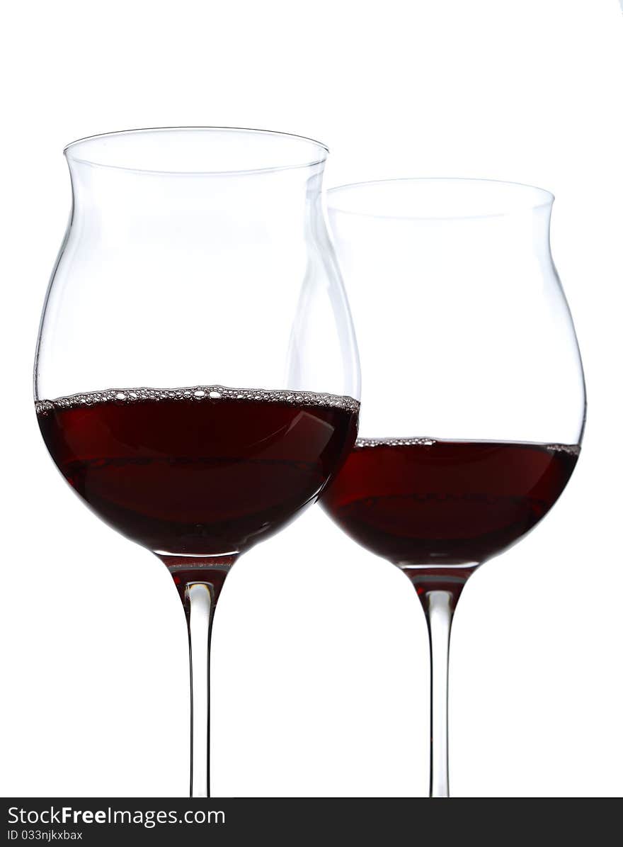 Half full wine glasses with red wine. Half full wine glasses with red wine