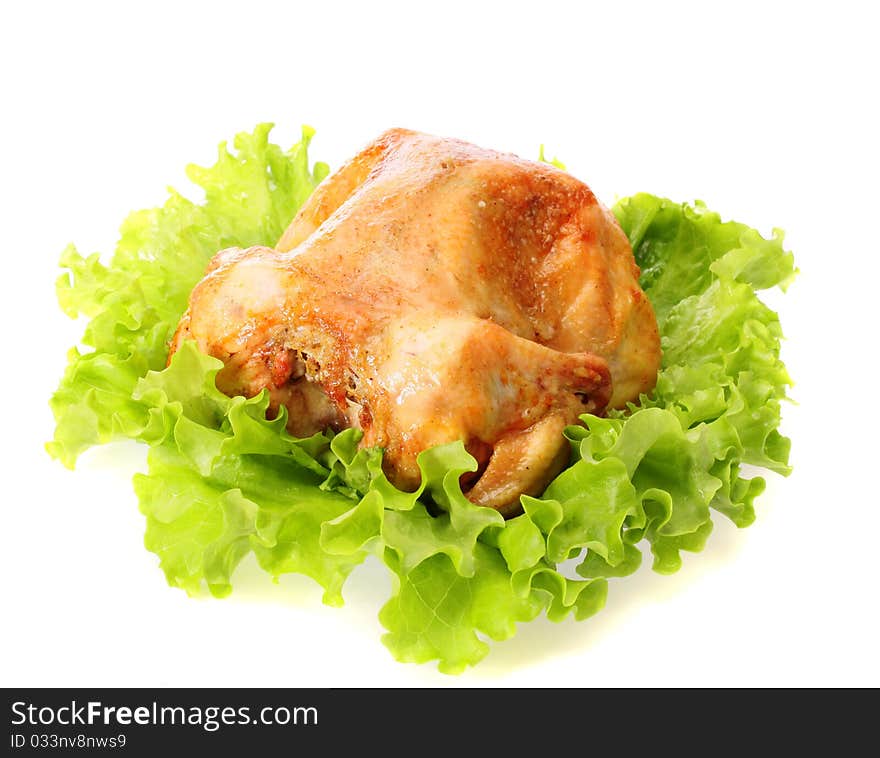 Roast chicken on leaves salad , isolated.