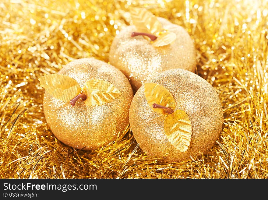 Golden apples lying on the golden background