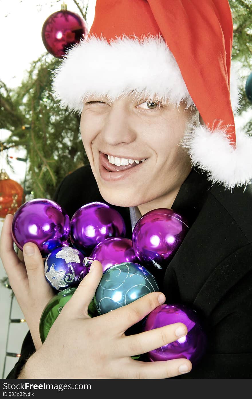 Man holds an armful of fur-tree toys