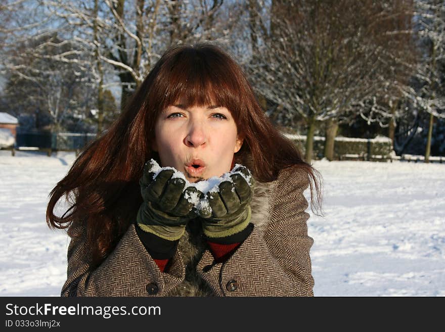 A 30s woman playing in the snow. A 30s woman playing in the snow