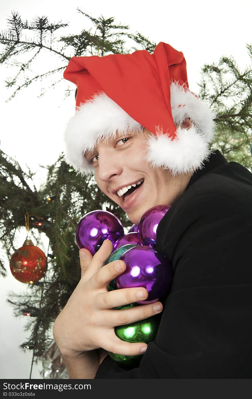 Young man holds an armful of fur-tree toys