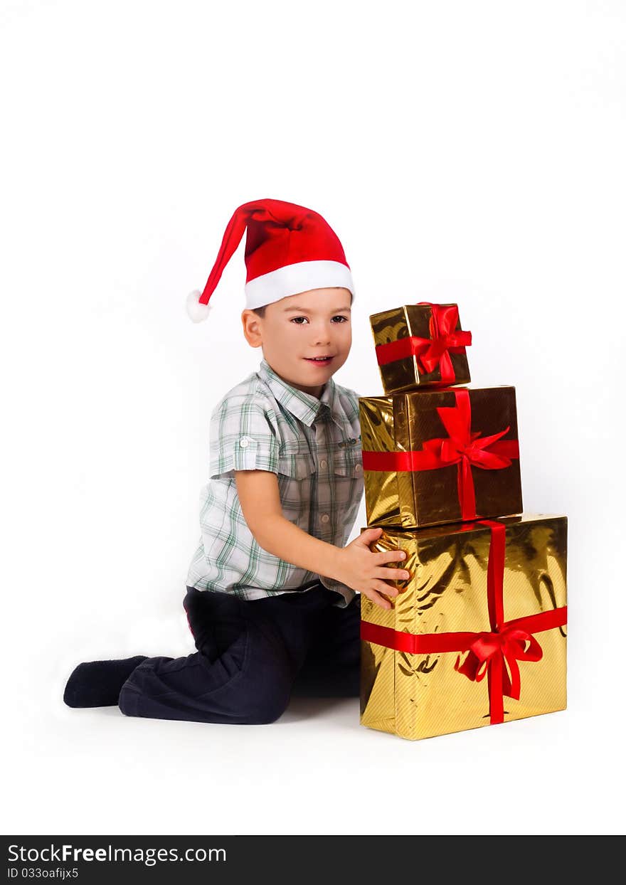 Boy In Santa Hat With A Bunch Of Gifts