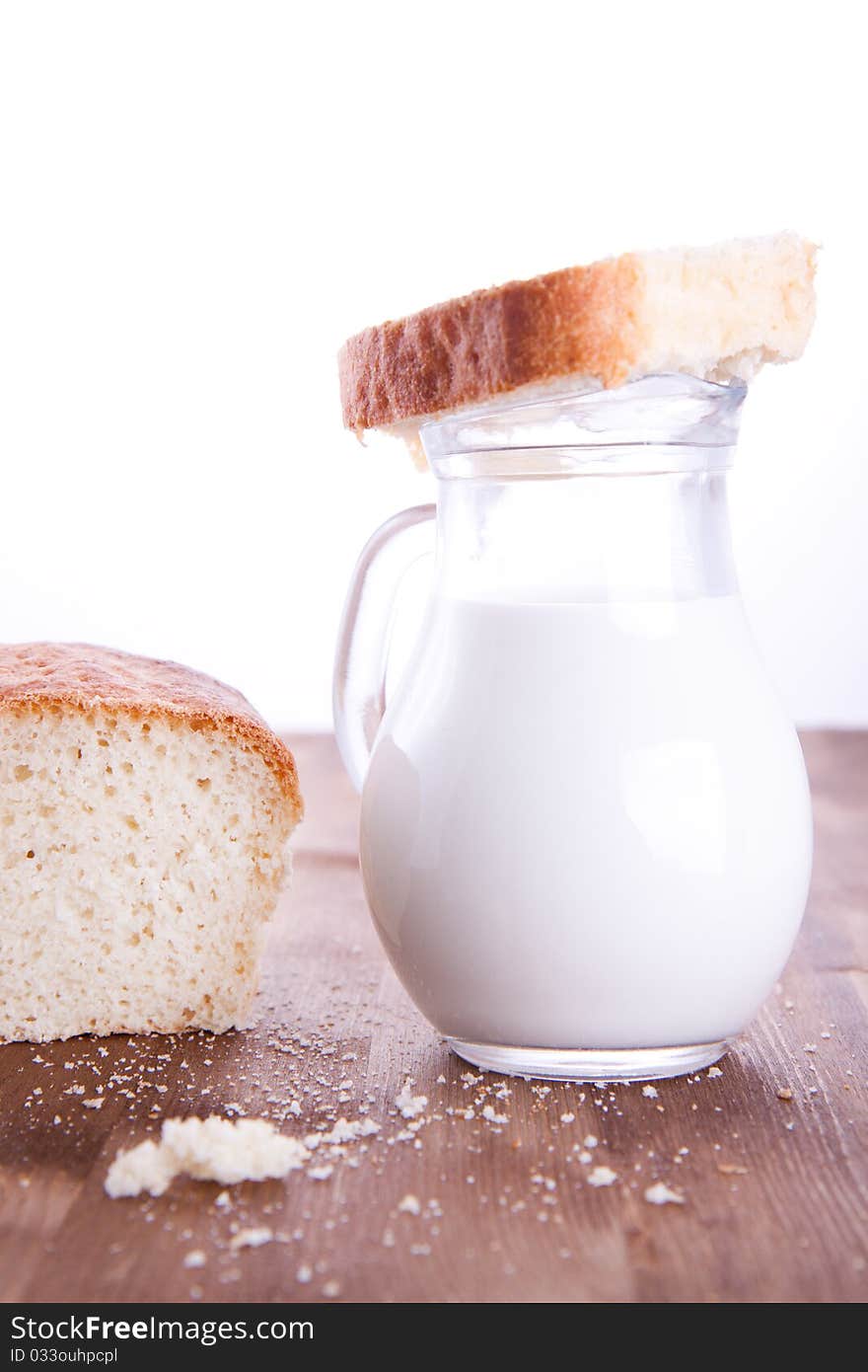 Fresh cooking bread with jug of milk. Fresh cooking bread with jug of milk