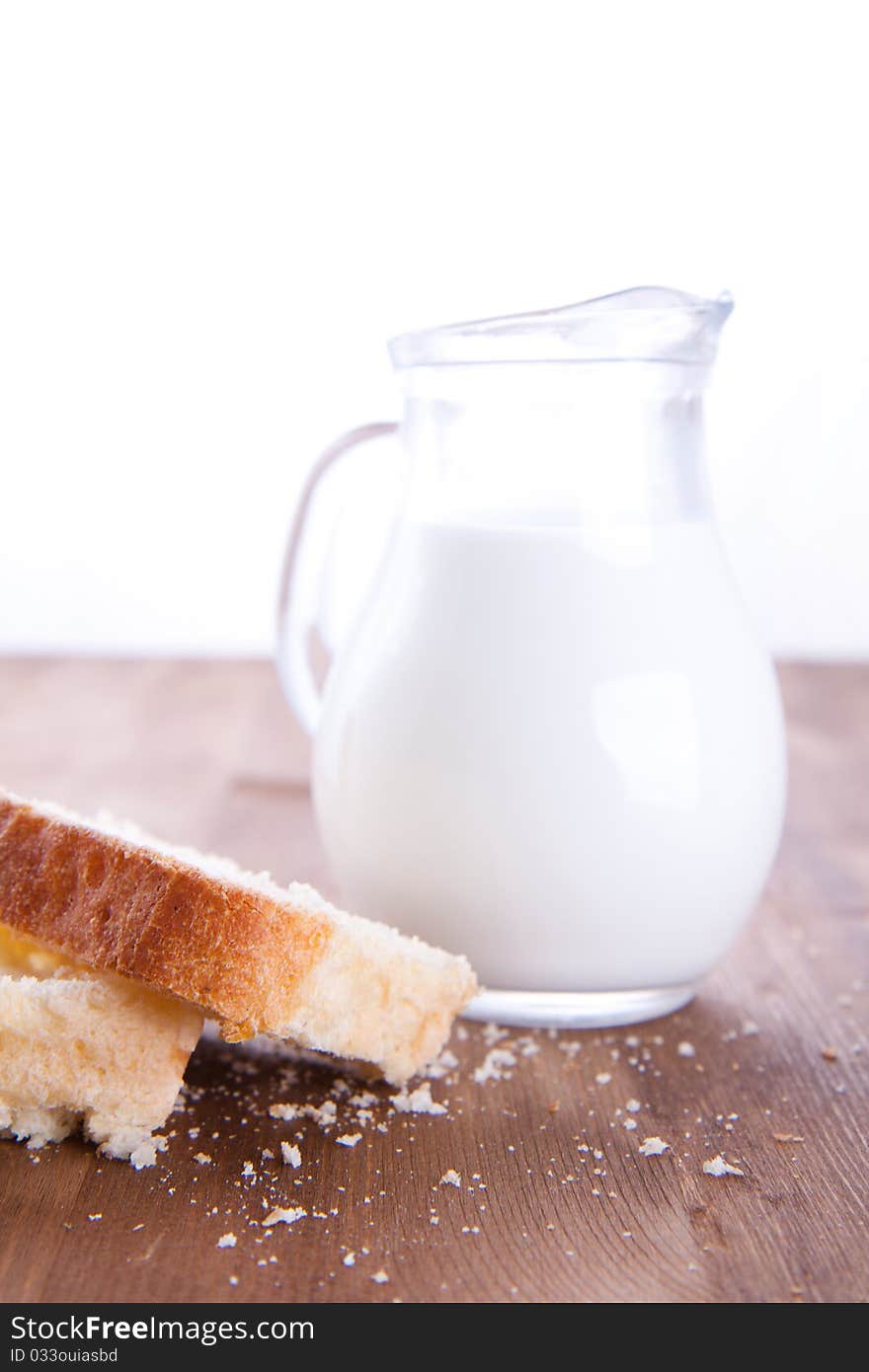 Fresh cooking bread with jug of milk. Fresh cooking bread with jug of milk