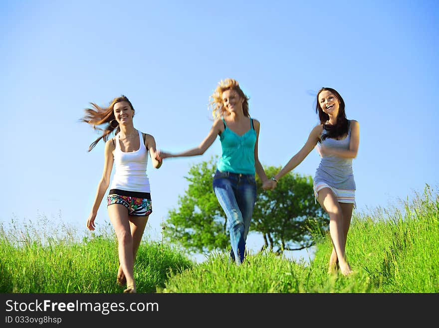 Fun smile girlfriends run by green field sun is shine. Fun smile girlfriends run by green field sun is shine