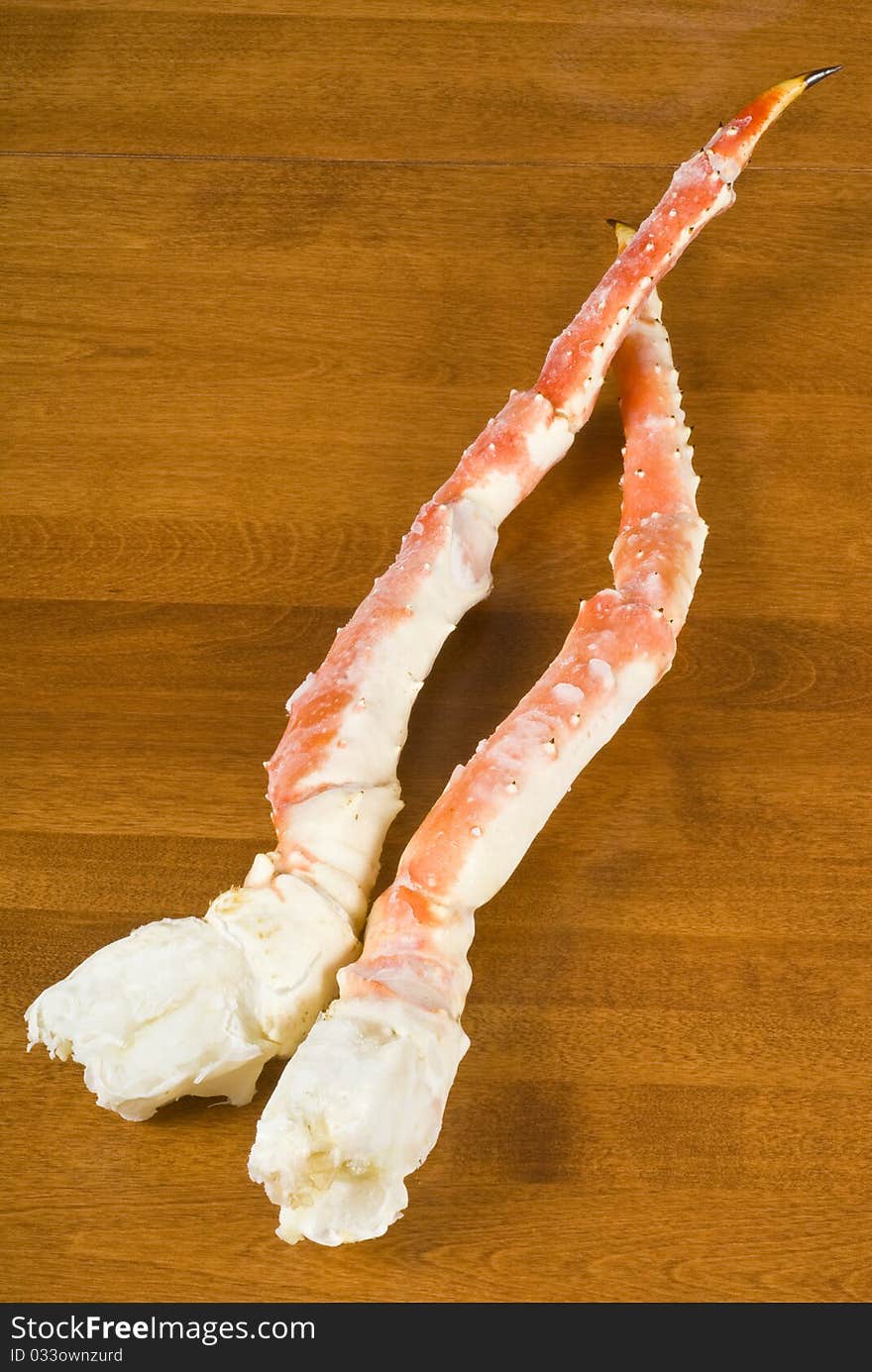 Pre-cooked frozen Alaskan King Crab legs on a table.