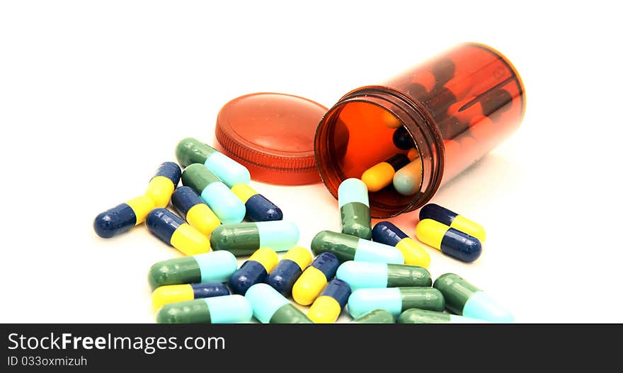 Colorful capsule spilling out from pill box