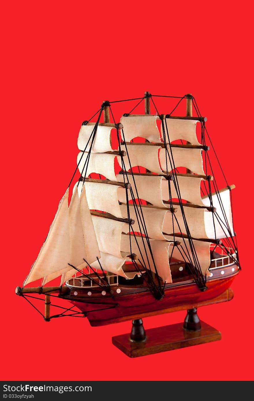 Isolated model of luxury sailboat on red background. Isolated model of luxury sailboat on red background