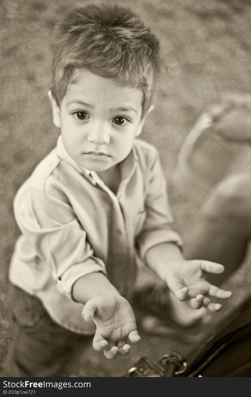 Little boy with open hands asking for something. Little boy with open hands asking for something