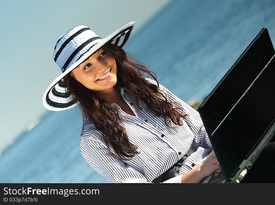 Woman work on laptop sea on background. Woman work on laptop sea on background