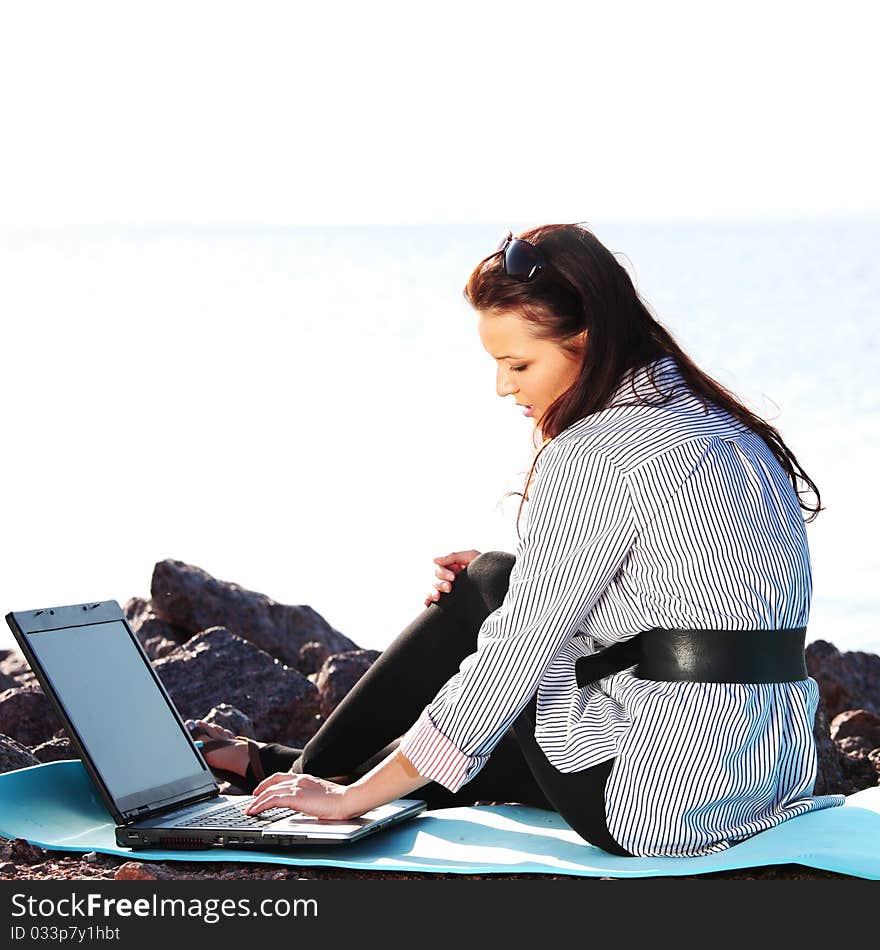 Woman work on laptop sea on background. Woman work on laptop sea on background