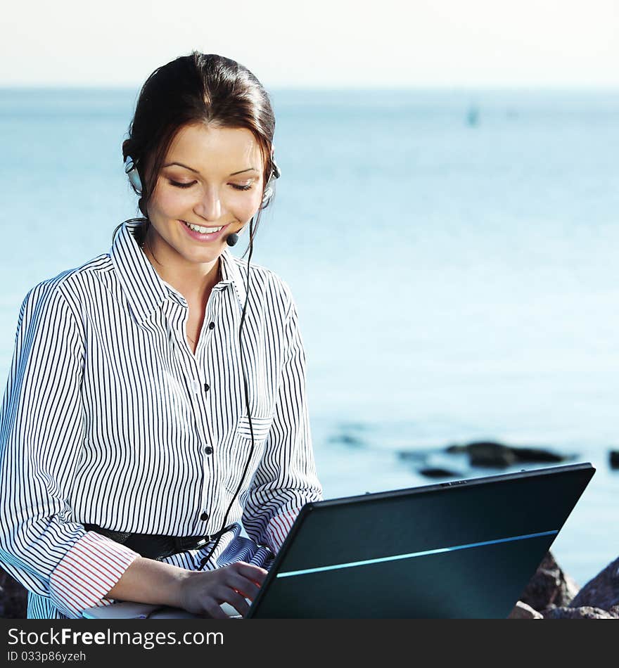 Woman work on laptop sea on background. Woman work on laptop sea on background