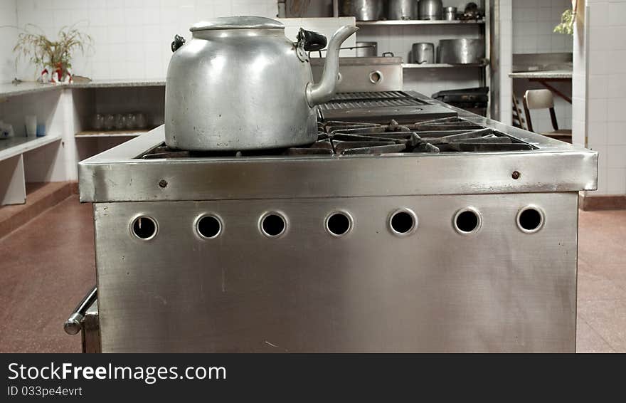 Restaurant kitchen with a kettle in the foreground