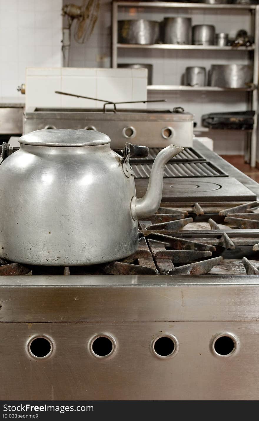 Restaurant kitchen with a kettle in the foreground