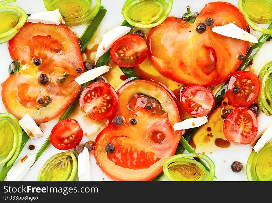 Salad with tomatoes isolated on white