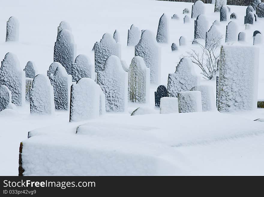 An old graveyard after a snow storm. An old graveyard after a snow storm