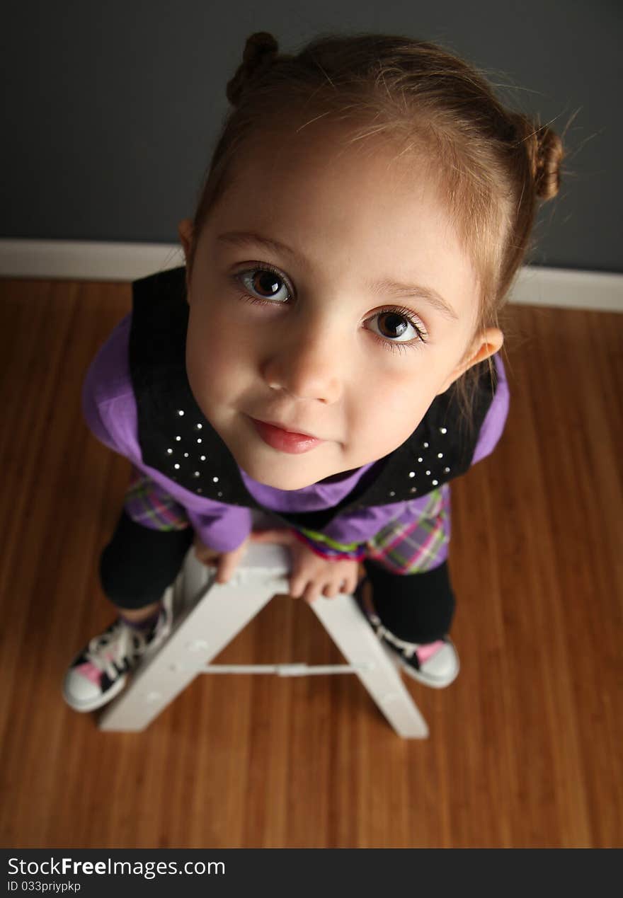 Girl sitting on ladder