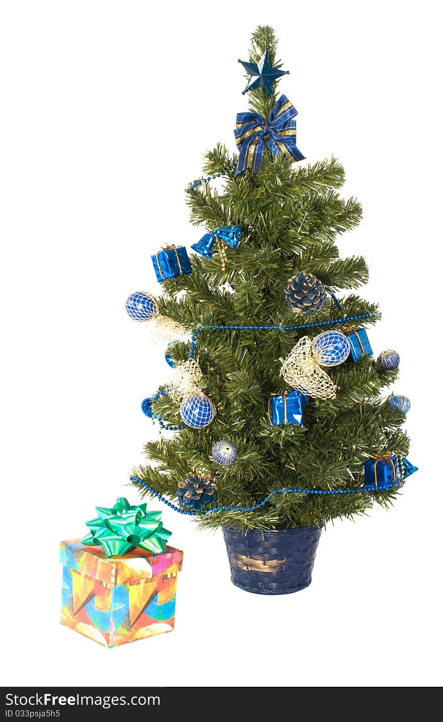 Gift box with a bow and artificial fur-tree on a white background. Gift box with a bow and artificial fur-tree on a white background.