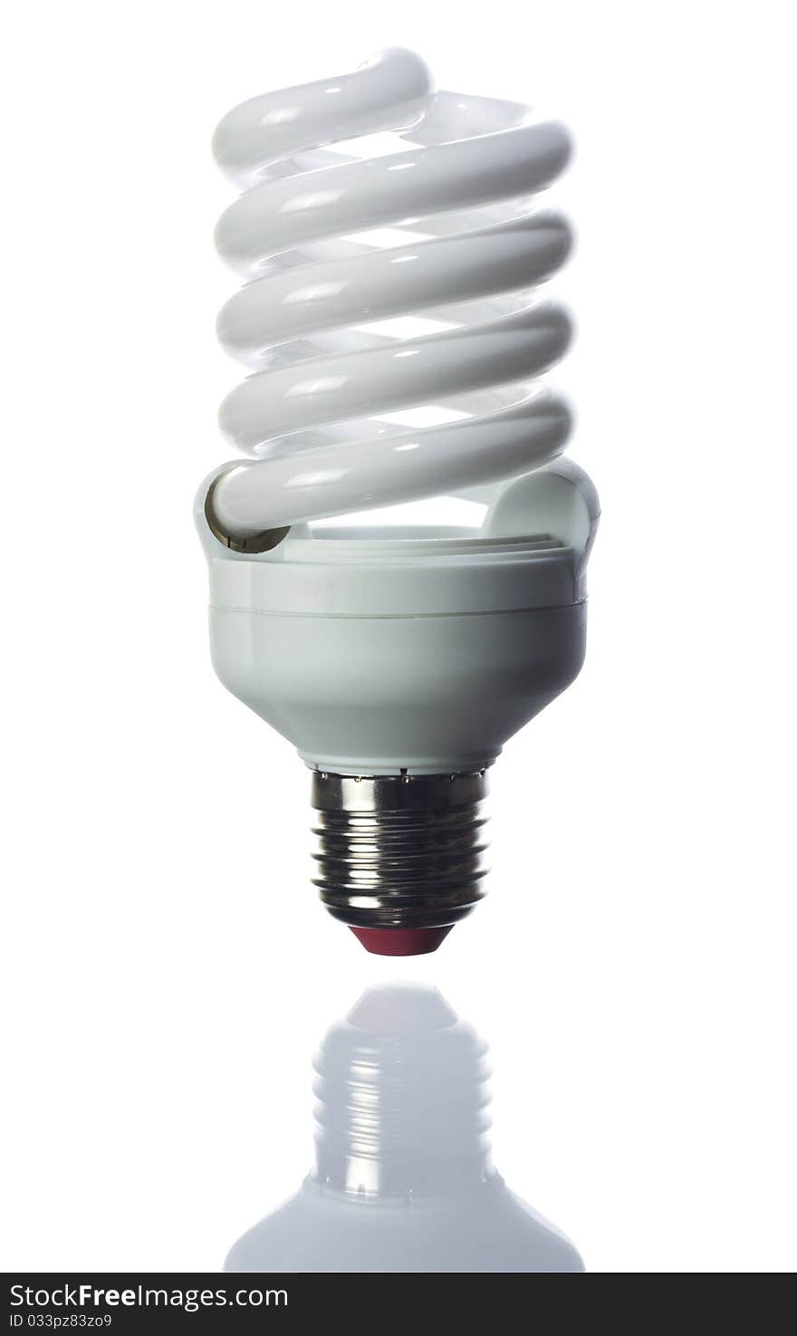 Compact fluorescent light bulb isolated over white background. Small reflection of the bottom.