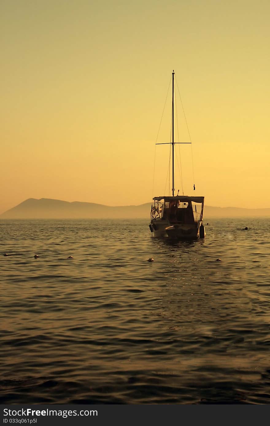 Sailing boat on the sea with the island in background. Sailing boat on the sea with the island in background.