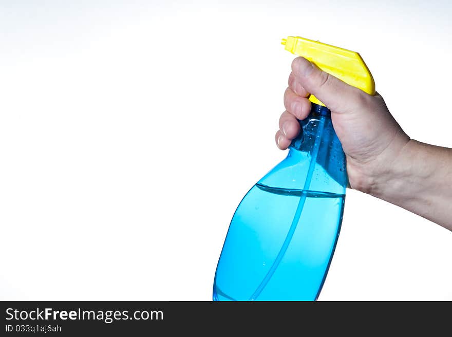 Hahd holding bottle of cleaning solution on the white background