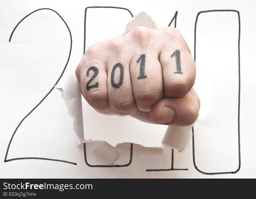 Hand punching through paper on white background