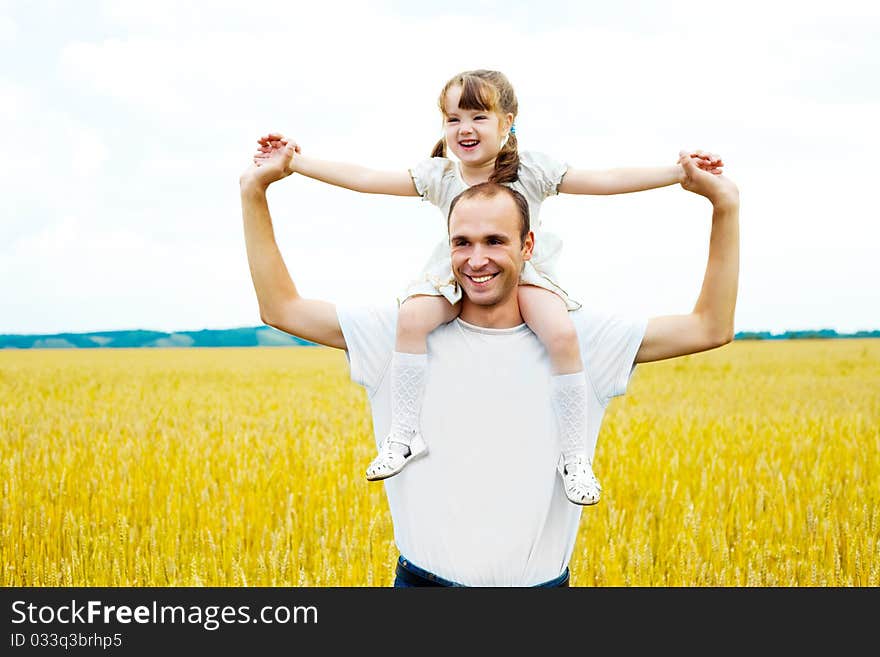 Happy young father and his daughter having fun at the wheat field. Happy young father and his daughter having fun at the wheat field