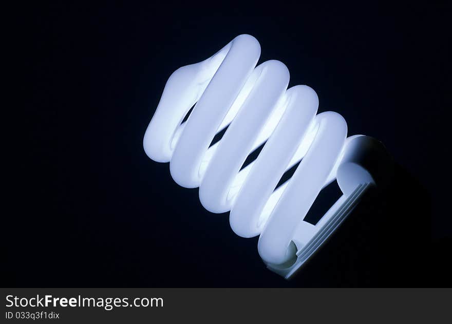 Spiral fluorescent lamp isolated on black background