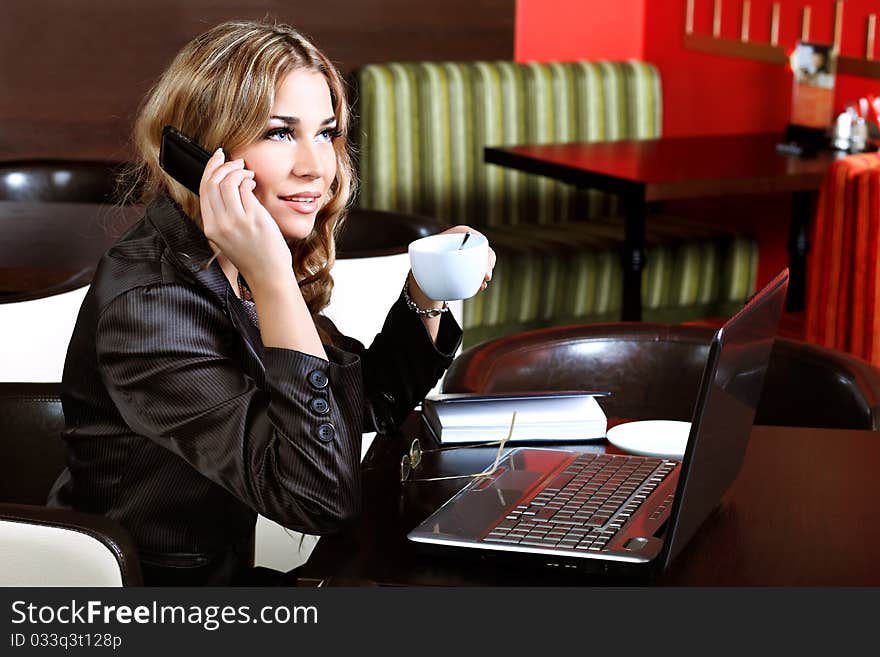 Young business woman having a break at a caf. Young business woman having a break at a caf