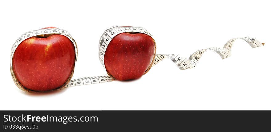 Red apple and tape measure close up