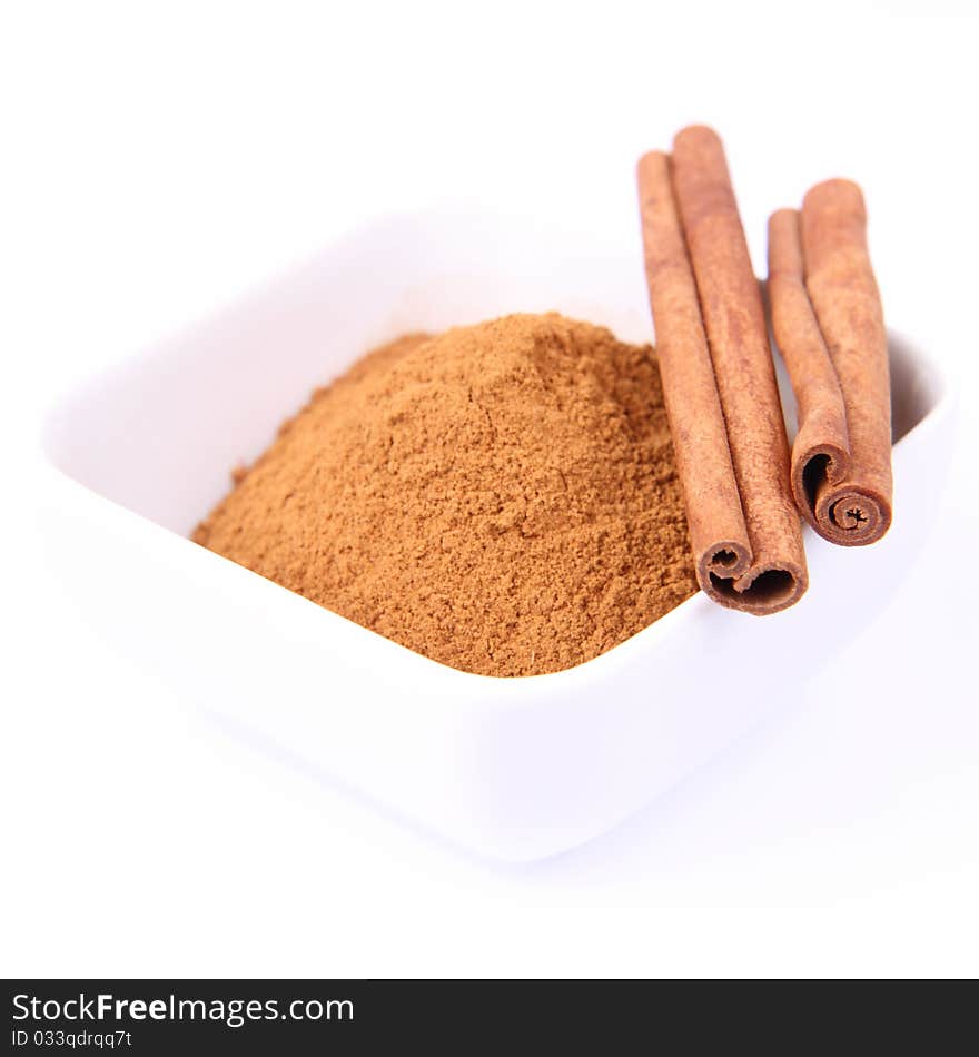 Cinnamon sticks and ground cinnamon on white background