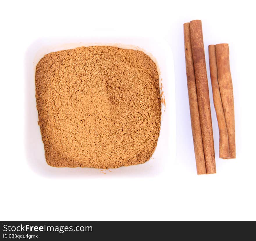 Cinnamon sticks and ground cinnamon on white background