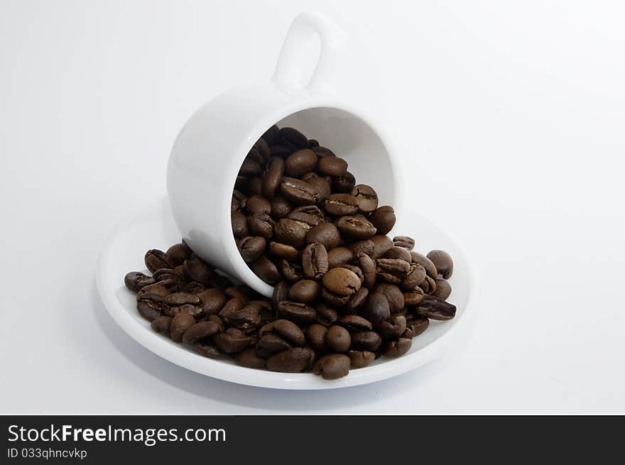 White cup with coffee beans