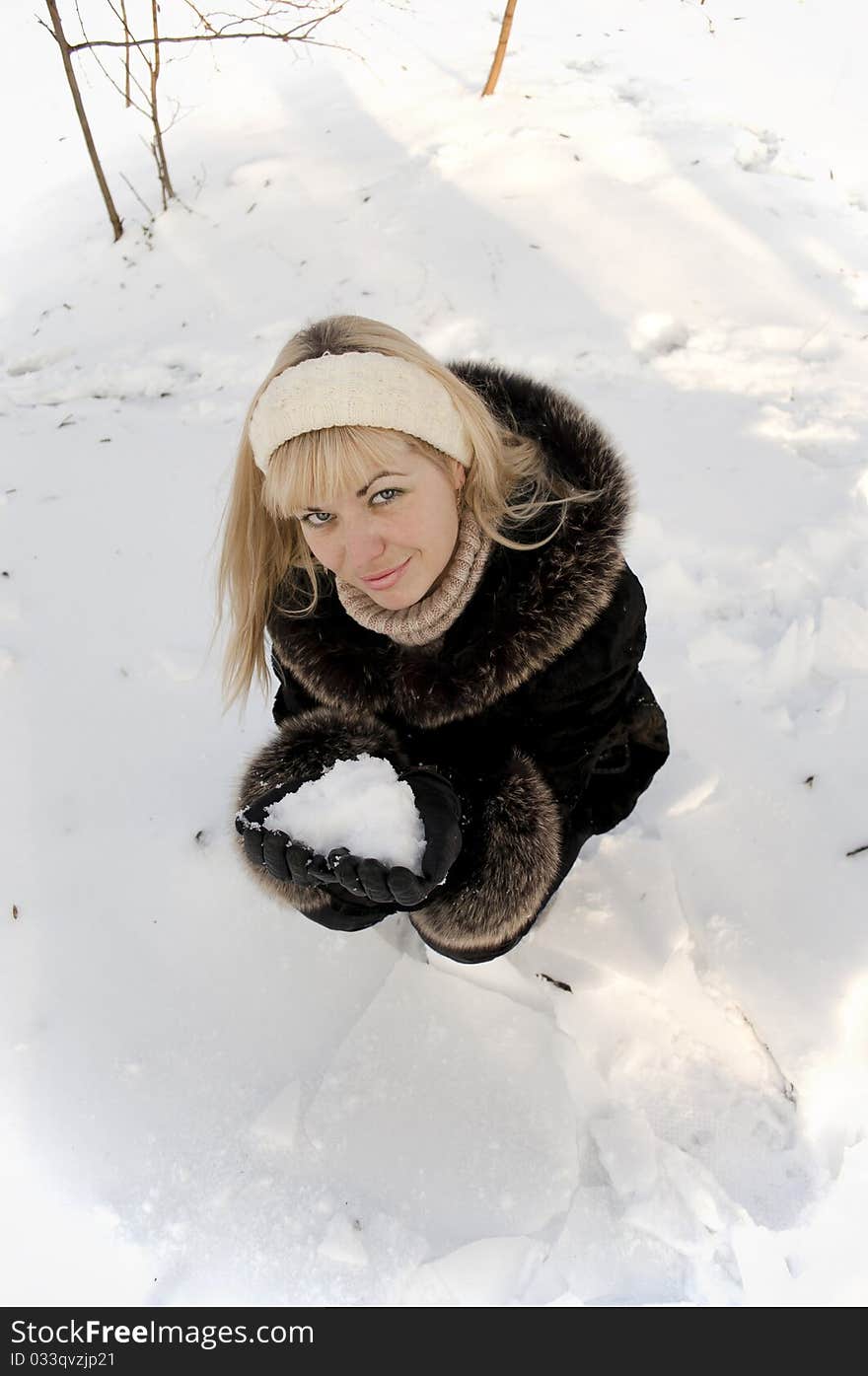 The smiling girl with snow in palms